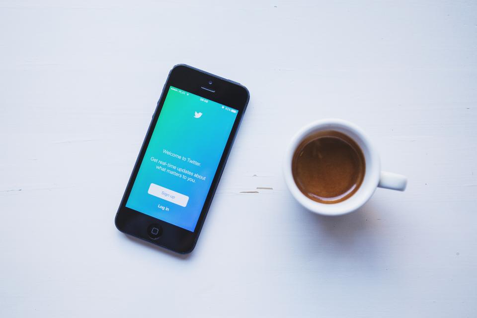 Phone and coffee on a white desk