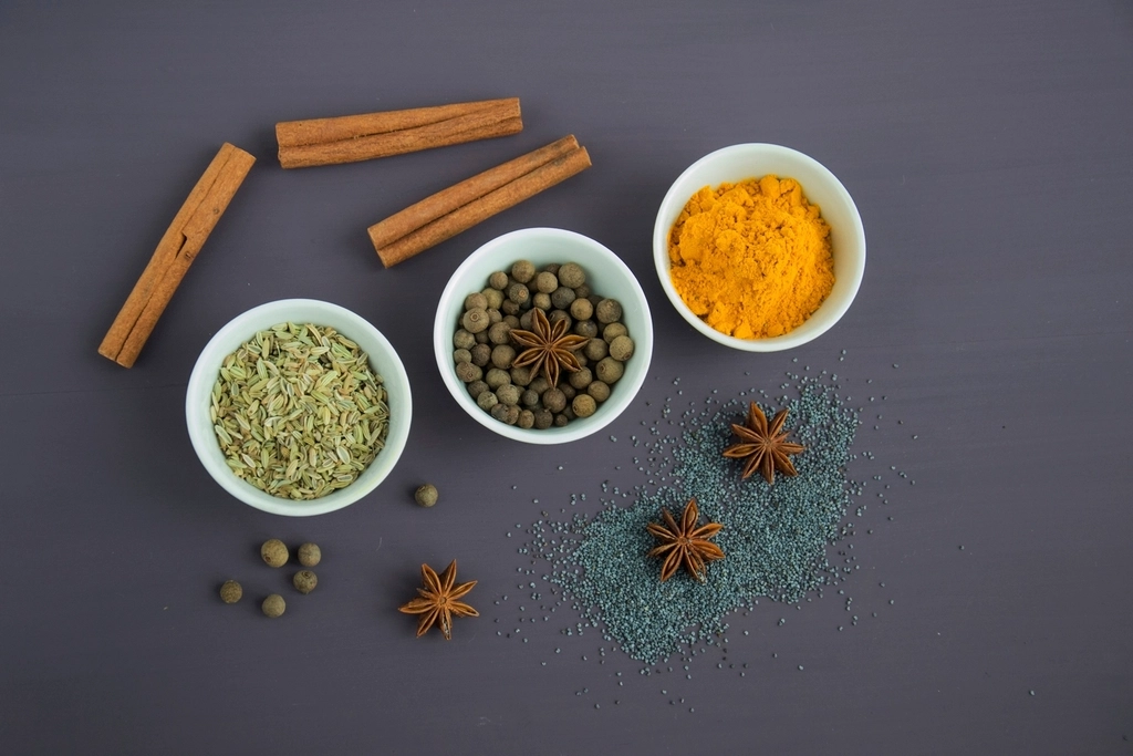 Natural spices and herbs in small bowls